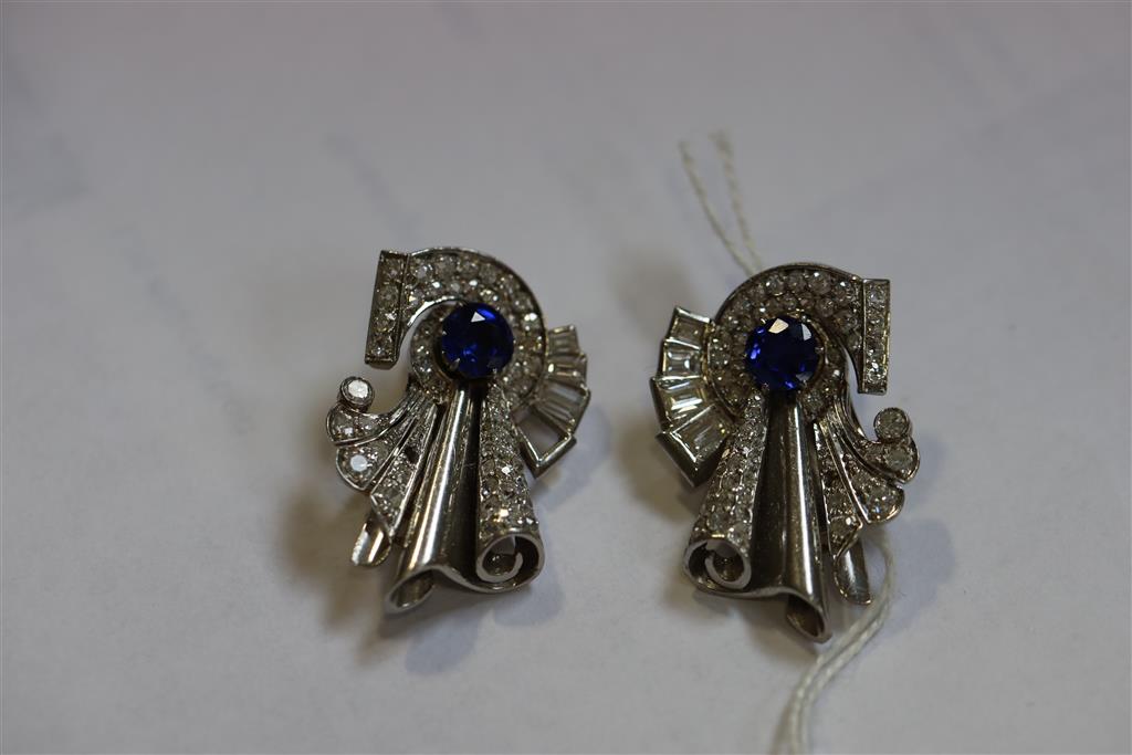 A pair of diamond and synthetic? sapphire clips in white metal settings (tests as platinum), white metal fitments